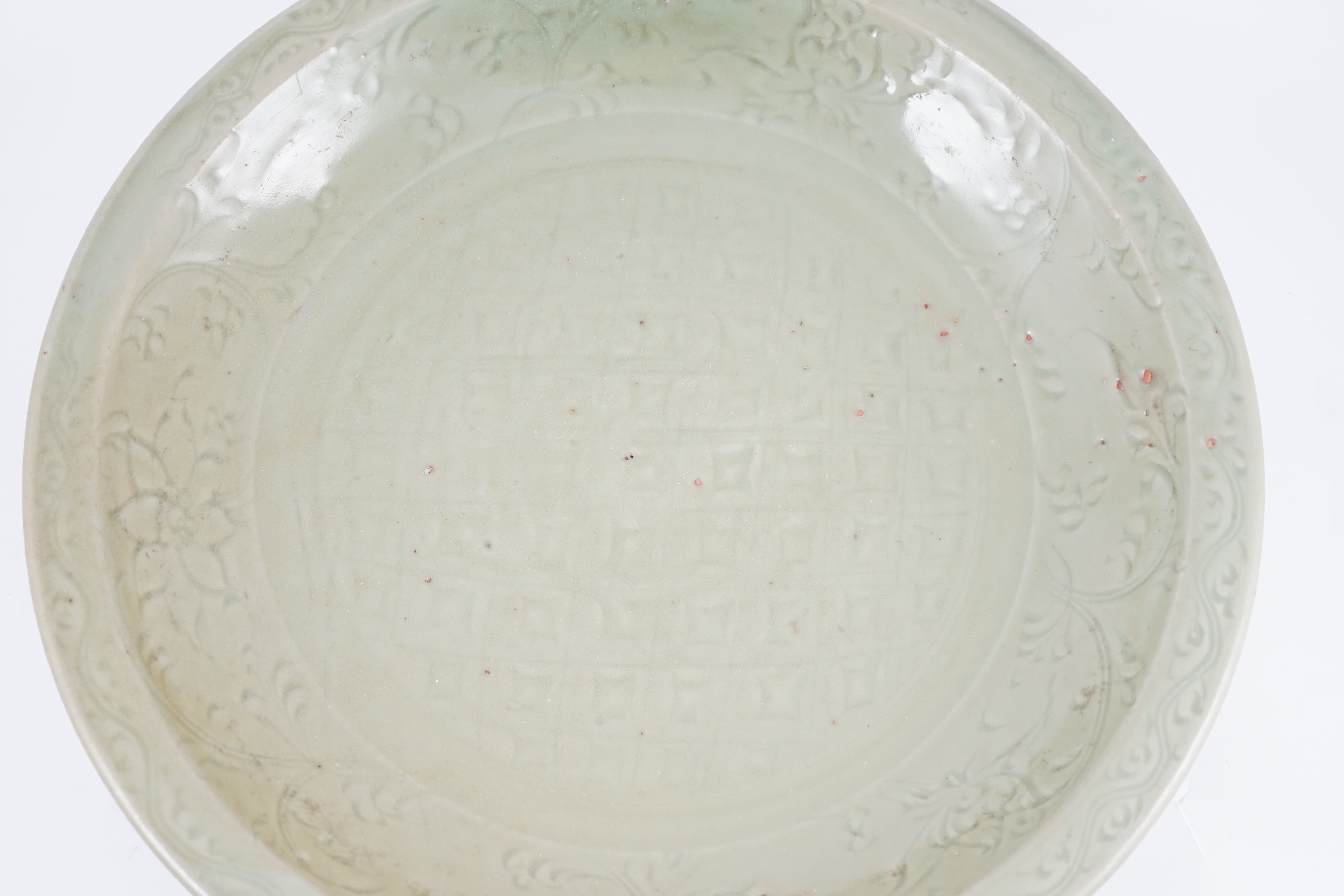 A Chinese Ming Longquan celadon ‘diaper and floral’ charger, 15th century, 45cm diameter, wear to glaze